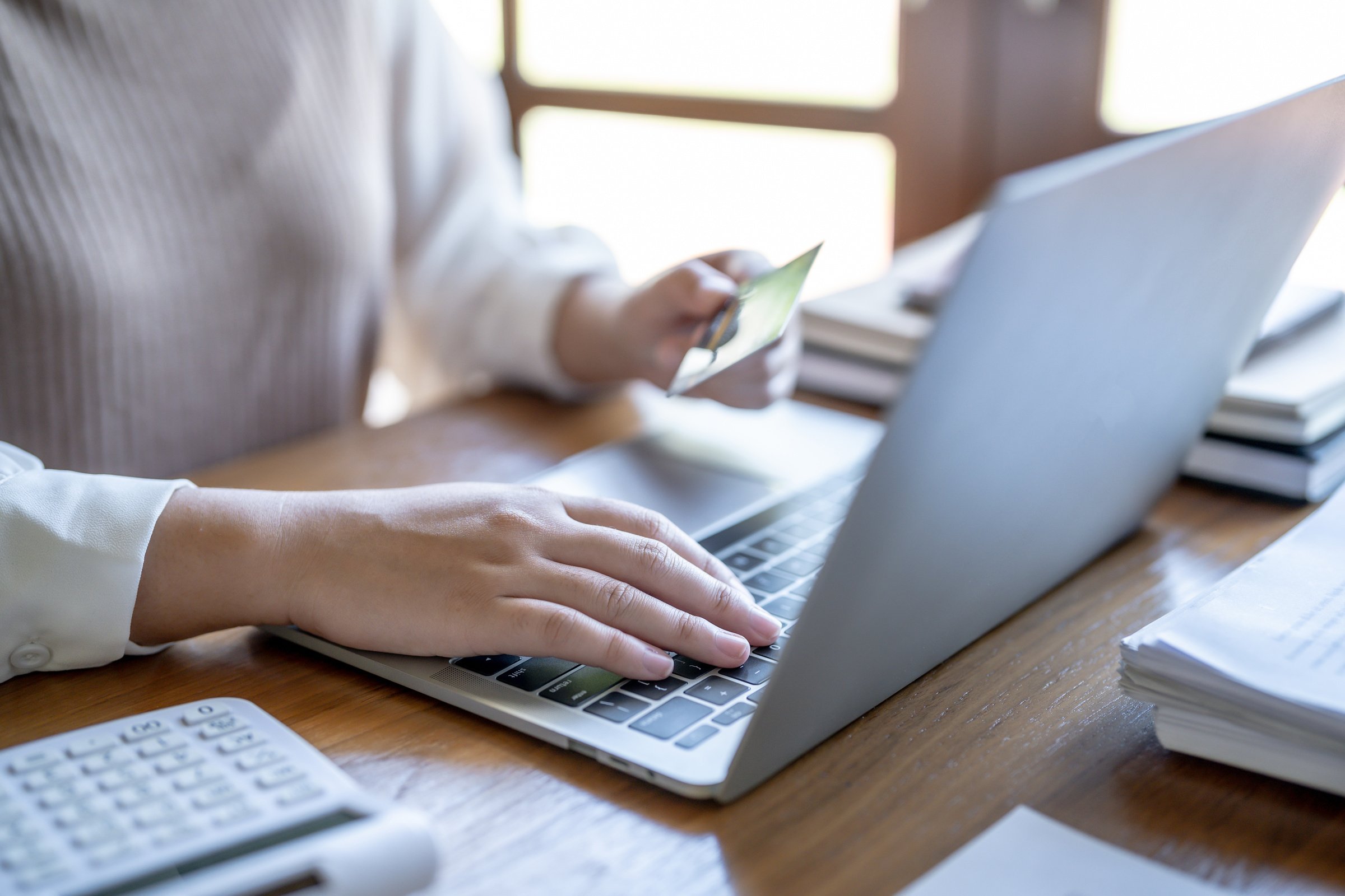 Woman Shopping on Laptop Holding Credit Card for Internet Onlin